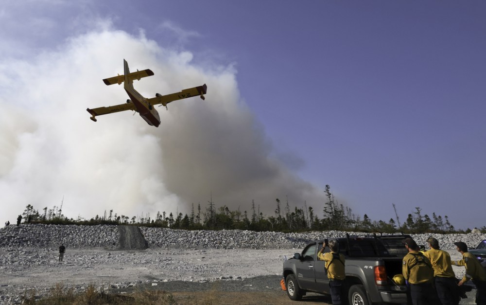 A water bomber makes a pass over the Susies Lake wildfire in Halifax Regional Municipality on Tuesday. (The Canadian Press)