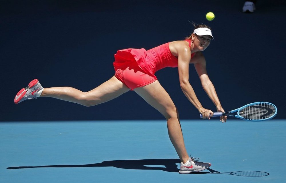 FILE - Russia's Maria Sharapova makes a backhand return to Croatia's Donna Vekic during their first round singles match at the Australian Open tennis championship in Melbourne, Australia, Jan. 21, 2020. (AP Photo/Lee Jin-man, File)