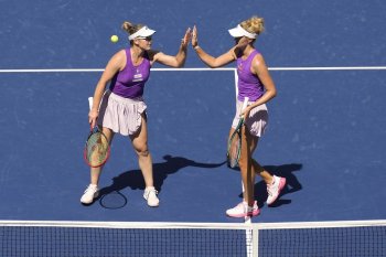 Ottawa native Gabriela Dabrowski and Montreal resident Erin Routliffe high five after a rally against American Taylor Townsend and Czechia's Katerina Siniakova during the women's doubles final of the U.S. Open tennis championships on Friday, Sept. 5, 2025, in New York. (AP Photo/Seth Wenig)