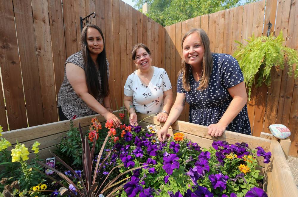 Leanne Bone (left), Kim Iwasiuk and Jamie Brown, staff members with the Women’s Resource Centre, are shown in the backyard of the centre’s new location at 1233 Rosser Ave. in Brandon. (Michele McDougall/The Brandon Sun)