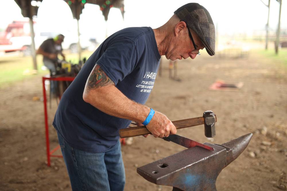 Michael Brown of Ontario works on making a kitchen knife with a hamon, a visible effect on a sword blade created by differential hardening.
