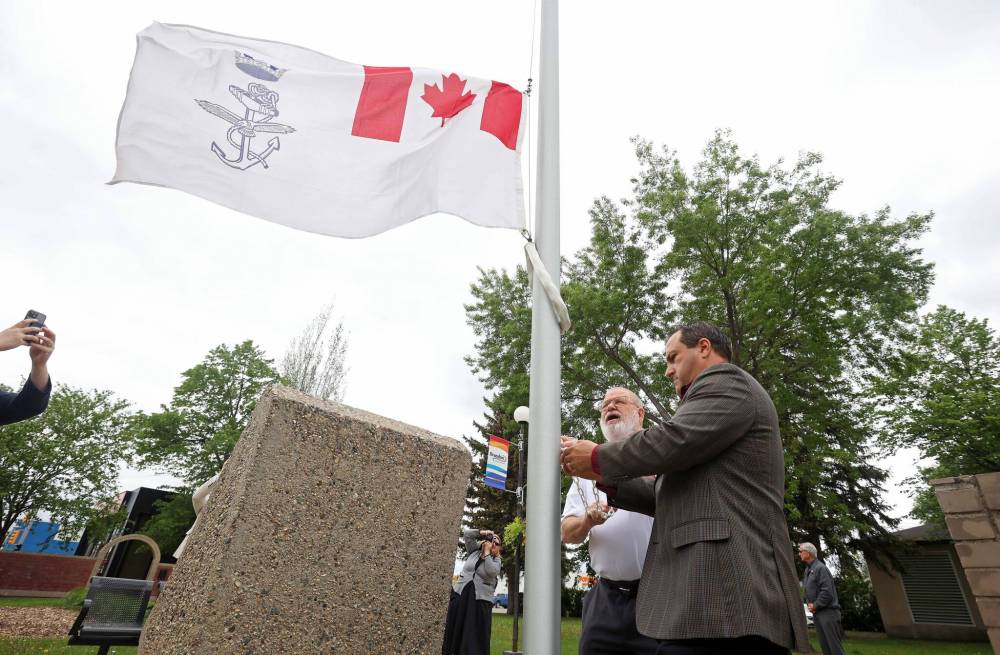 George Haggerty with Brandon Salutes and Brandon City Councillor and acting Mayor Jason Splett raise the Royal Canadian Navy ensign at city hall last year in honour of the city's namesake ship HMCS Brandon's 25 years of service. Haggerty is speaking out in support of Sun columnist Deveryn Ross' idea to bring the HMCS Brandon to the Wheat City. (Tim Smith/The Brandon Sun files)