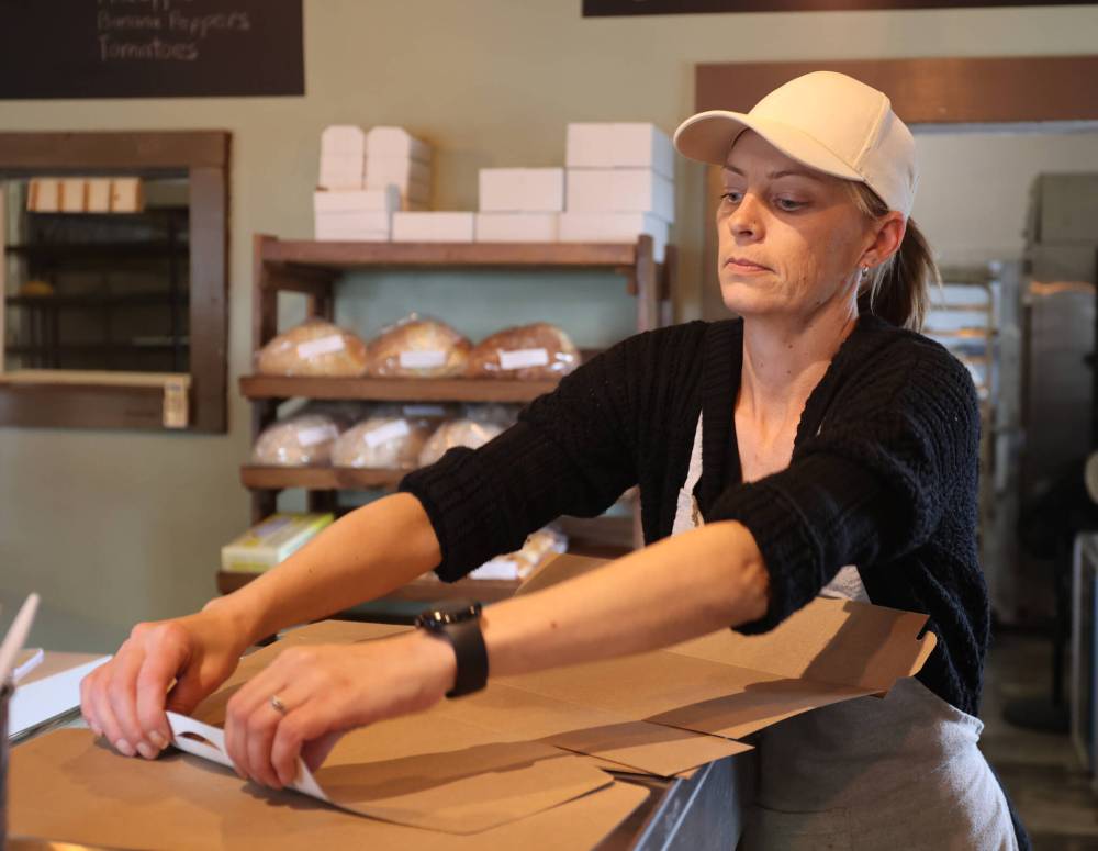Glenboro Bake Shop owner Tara Wilson prepares donut boxes at her business in Glenboro on Tuesday. (Photos by Alex Lambert/The Brandon Sun)