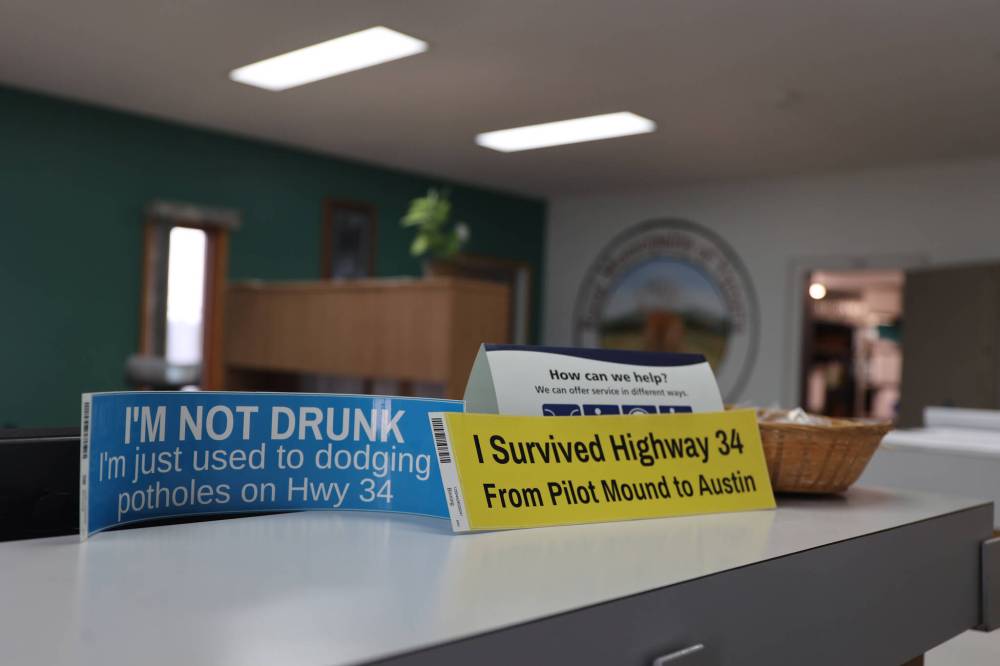 Bumper stickers mocking the egregious state of Highway 34 sit in the RM of Victoria office in Holland on Tuesday. The highway was voted the worst road in Manitoba in May.