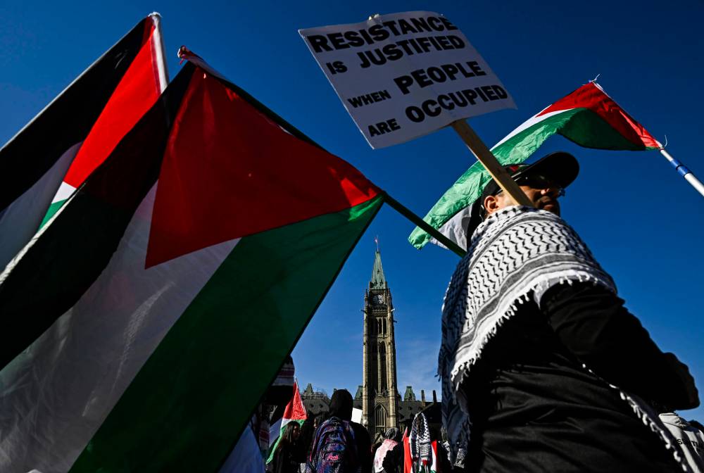 Pro-Palestine demonstrators take part in a rally on Parliament Hill in Ottawa in October 2024. Canada has announced it will recognize Palestinian statehood in September, provided certain conditions are met. (The Canadian Press files)