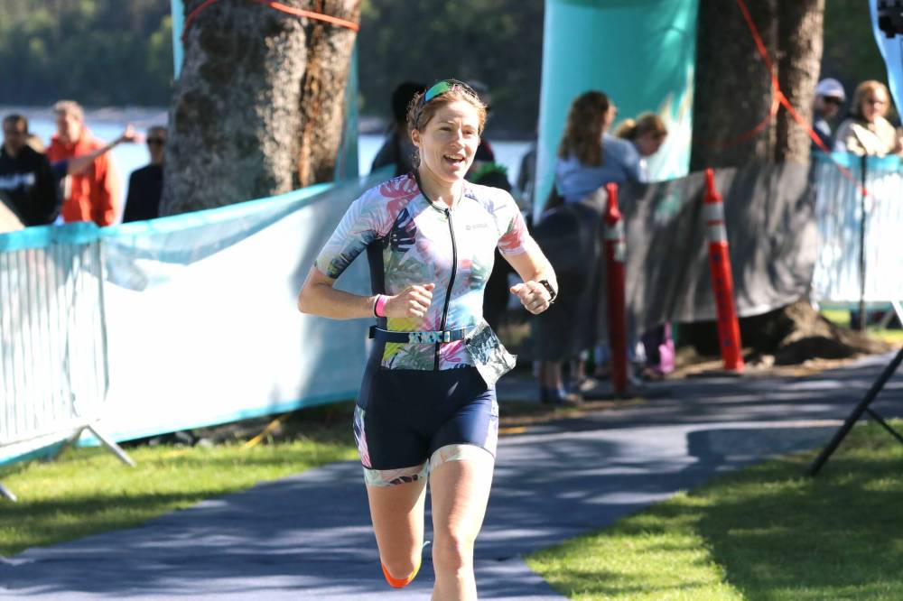 Olympic women's race winner Bronwyn Russel (1152) smiles as she reaches the finish line at the Riding Mountain Triathlon in Wasagaming on Saturday. (Perry Bergson/The Brandon Sun)
