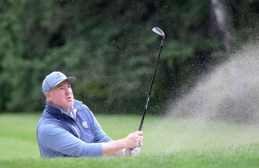 Josh McPhail hits a bunker shot during his second straight even-par 72 to finish qualifying tied for second. (Thomas Friesen/The Brandon Sun)