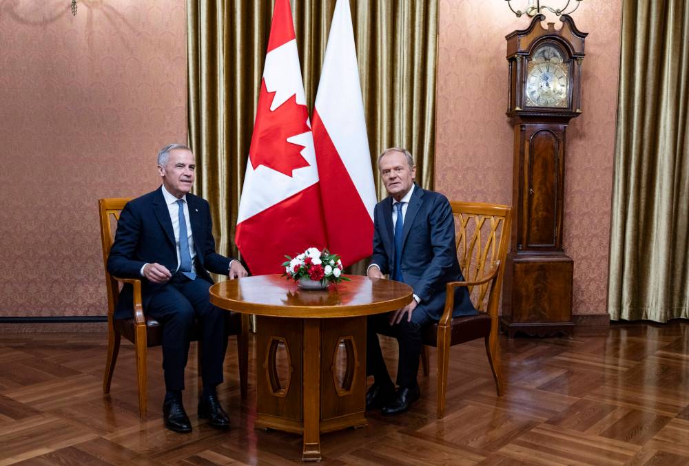 Prime Minister Mark Carney (left) has a bilateral meeting with Polish Prime Minister Donald Tusk at the Chancellery of the Prime Minister in Warsaw, Poland on Monday. (The Canadian Press)
