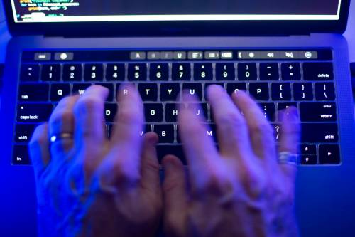 A man uses a computer keyboard in Toronto in October 2023 in this photo illustration. Columnist Neil McArthur questions the effectiveness of age verification laws and their impact on free speech. (The Canadian Press files)