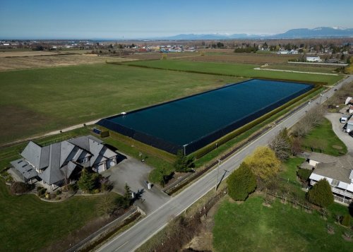 In this photograph taken with a drone, a water storage area is seen near on farmland at Westcoast Vegetables in Delta, B.C., on Monday, March 18, 2024. THE CANADIAN PRESS/Darryl Dyck