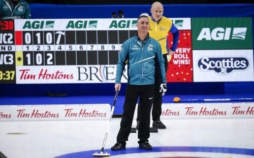 Team Wild Card Three alternate Wayne Middaugh, left, directs his teammates as Team Wild Card Two skip Kevin Koe looks on at the Brier in Calgary, Alta., Saturday, March 13, 2021. THE CANADIAN PRESS/Jeff McIntosh