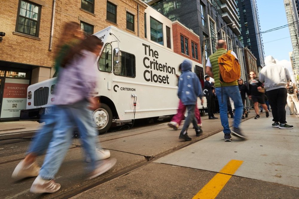 Festivalgoers pass the Criterion Closet mobile video library during its stop at the Toronto International Film Festival in Toronto, on Sunday, Sept. 7, 2025. THE CANADIAN PRESS/Sammy Kogan