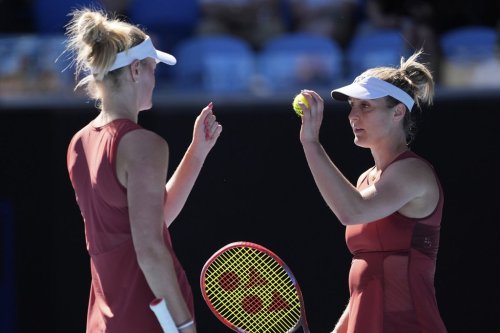 Canada's Gabriela Dabrowski, right, reacts with partner Erin Routliffe of New Zealand during their women's doubles semifinal against Hsieh Su-Wei of Taiwan and Jelena Ostapenko of Latvia at the Australian Open tennis championship in Melbourne, Australia, Friday, Jan. 24, 2025. (AP Photo/Ng Han Guan)