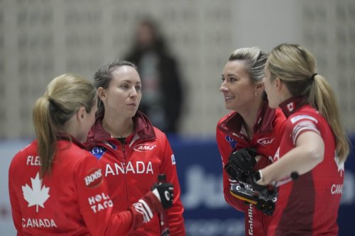 Canada's skip Rachel Homan, second from left, speaks to her players during the qualification match against Scotland at the World Women's Curling Championship in Uijeongbu, South Korea, Saturday, March 22, 2025. (AP Photo/Lee Jin-man)