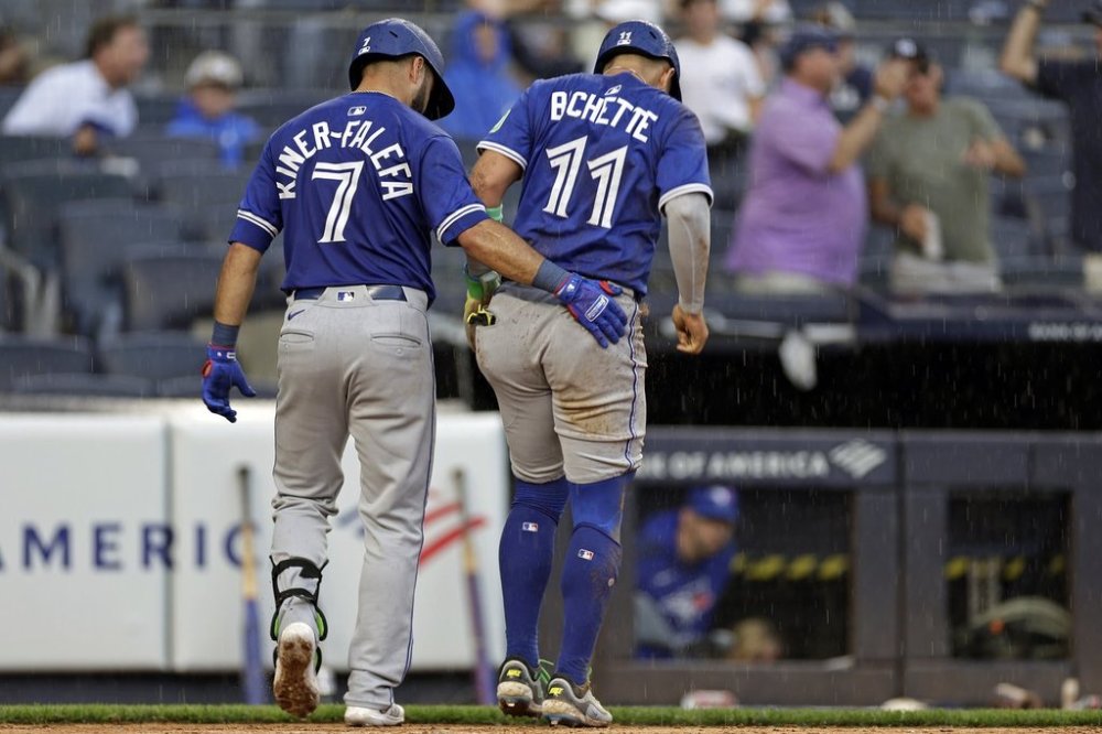 Toronto Blue Jays' Bo Bichette (11) is helped off the field by Isiah Kiner-Falefa (7) after being tagged out at home during the sixth inning of a baseball game against the New York Yankees, Saturday, Sept. 6, 2025, in New York. (AP Photo/Adam Hunger)