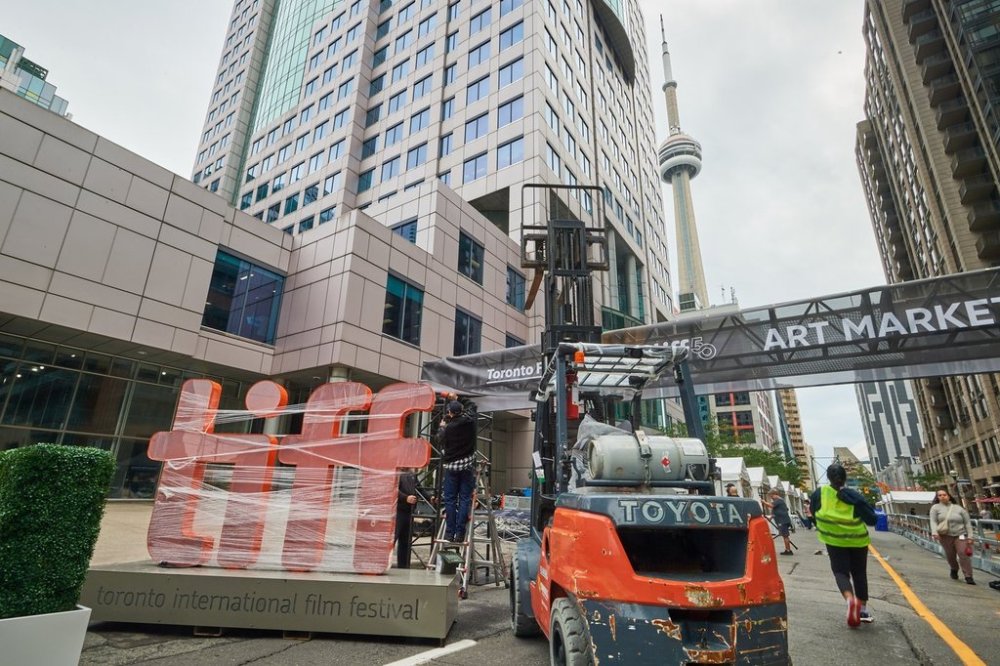 Pedestrians walk by a covered TIFF sign as preparations for the Toronto International Film Festival continue in Toronto, on Thursday, Sept. 4, 2025. THE CANADIAN PRESS/Sammy Kogan