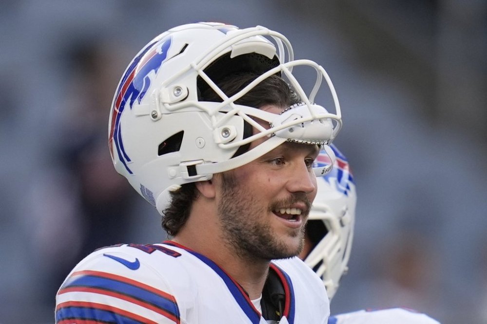 Buffalo Bills quarterback Josh Allen talks with teammates during warmups before a preseason NFL football game against the Chicago Bears Sunday, Aug. 17, 2025, in Chicago. (AP Photo/Erin Hooley)