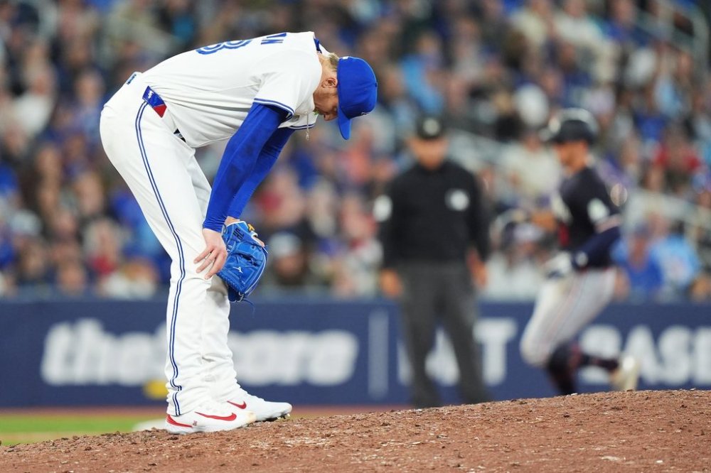 Blue Jays pitcher Jeff Hoffman (left) reacts after giving up a three-run home run to Minnesota Twins outfielder Matt Wallner (back right) during the ninth inning of a Major League Baseball game in Toronto on Tuesday, Aug. 26, 2025. THE CANADIAN PRESS/Frank Gunn