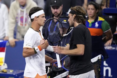 Daniel Altmaier, left, of Germany, is congratulated by Stefanos Tsitsipas, of Greece, after defeating him during the second round of the U.S. Open tennis championships, Thursday, Aug. 28, 2025, in New York. (AP Photo/Frank Franklin II)