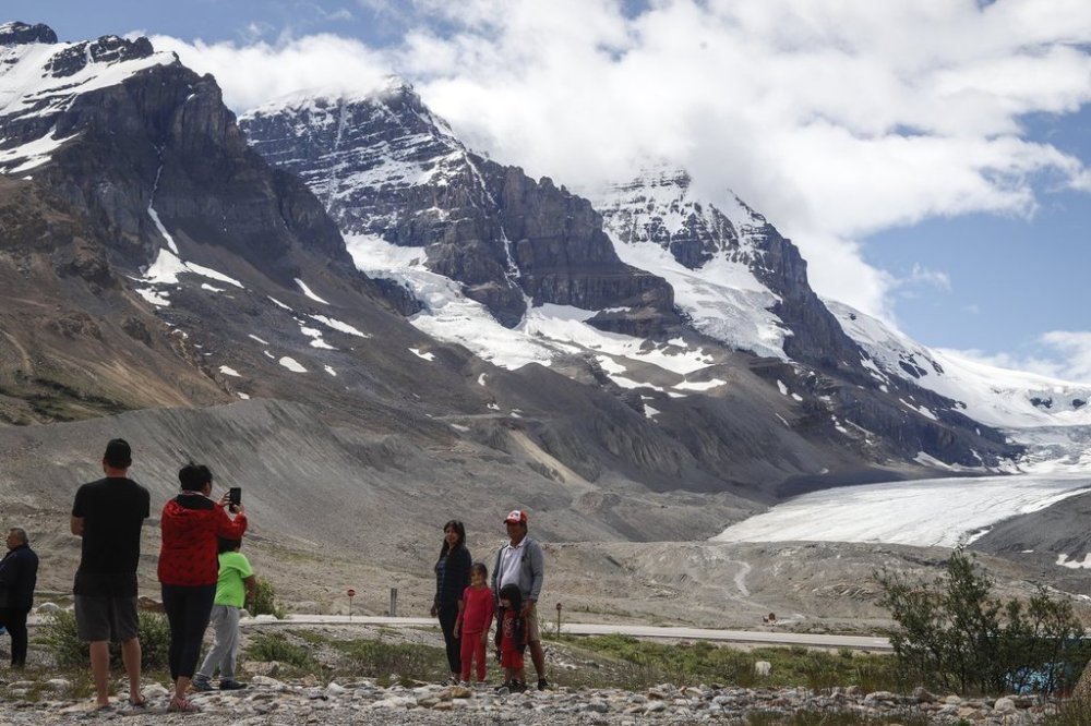 Tourists take photos at the Columbia Icefields near Jasper, Alta., Sunday, July 19, 2020. THE CANADIAN PRESS/Jeff McIntosh