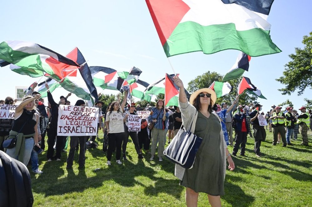 Pro Palestine people demonstrate against the participation of cyclists racing for Israel Premier-Tech at the Grand Prix Cycliste de Quebec, Friday, Sept. 12, 2025 in Quebec City. THE CANADIAN PRESS/Jacques Boissinot