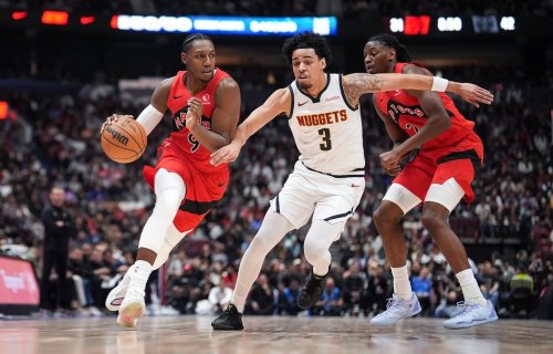 Toronto Raptors' RJ Barrett, left, drives past Denver Nuggets' Julian Strawther, centre, in front of Toronto's Jonathan Mogbo, back right, during the first half of a pre-season NBA basketball game, in Vancouver, B.C., Monday, Oct. 6, 2025. THE CANADIAN PRESS/Darryl Dyck