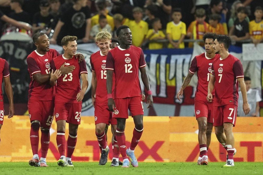Canada's Niko Sigur, second from left, celebrates after scoring his side's third goal during an international friendly soccer match between Romania and Canada at the National Arena stadium in Bucharest, Romania, Friday, Sept. 5, 2025. (AP Photo/Andreea Alexandru)