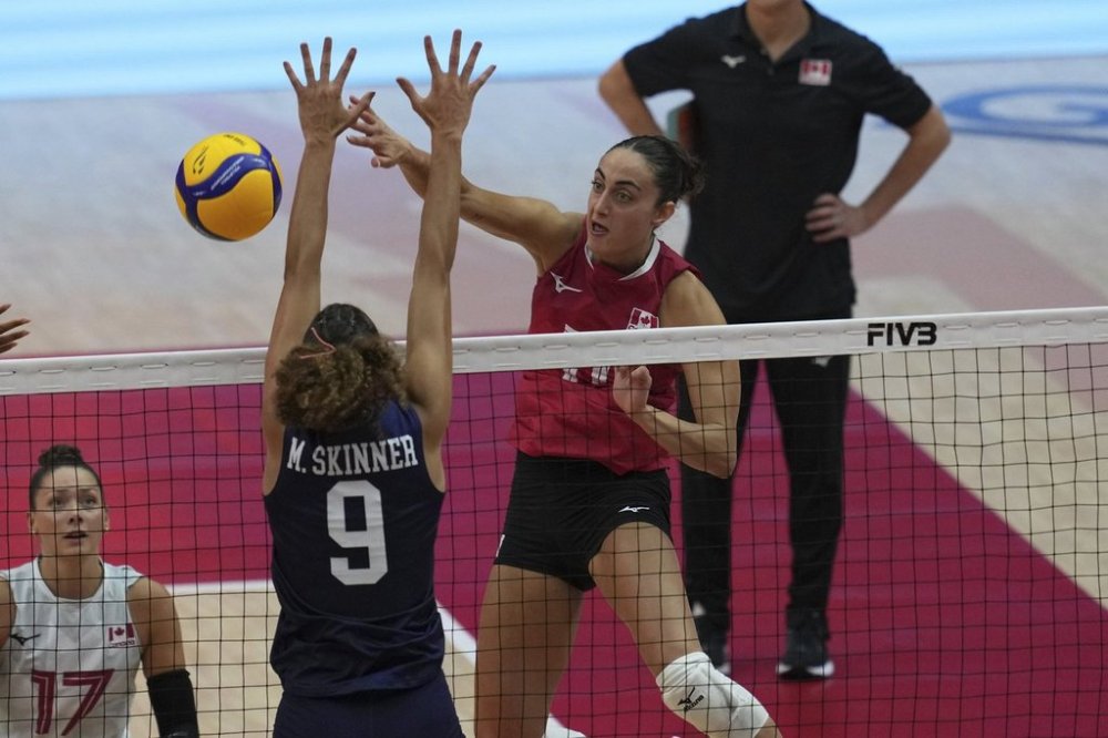 Canada's Andrea Mitrovic, right, spikes the ball against United States' Madisen Skinner, front, during the FIVB Women's Volleyball World Championship 2025 second round match between U.S. and Canada at Indoor stadium Huamark in Bangkok, Thailand, Monday, Sept. 1, 2025. (AP Photo/Sakchai Lalit)