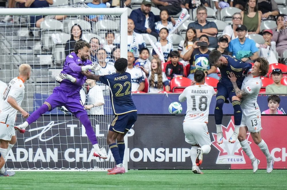 Vancouver Whitecaps' Tristan Blackmon, second right, scores against Forge FC goalkeeper Jassem Koleilat, back left, as Alexander Achinioti-Jonsson (13) and Molham Babouli (18) defend while Vancouver's Ali Ahmed (22) watches during the first half of a Canadian Championship semifinal soccer match, in Vancouver, on Tuesday, Sept. 16, 2025. THE CANADIAN PRESS/Darryl Dyck
