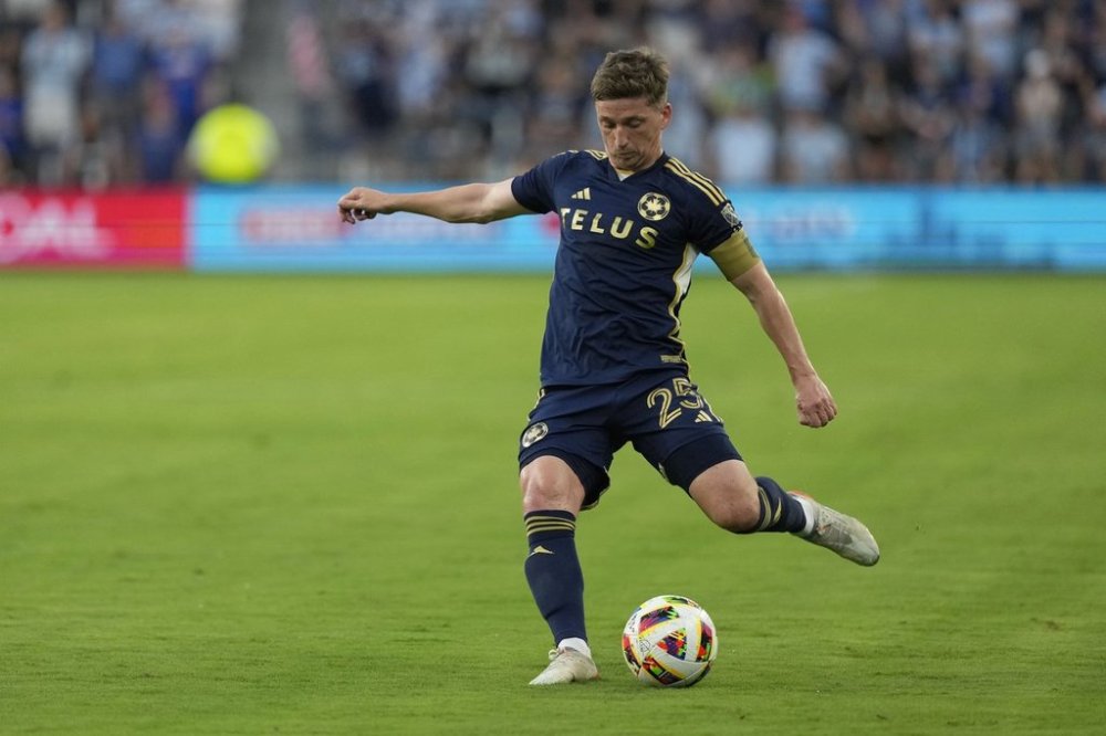 Vancouver Whitecaps attacker Ryan Gauld kicks the ball during the first half of an MLS soccer match Wednesday, May 29, 2024, in Kansas City, Kan. (AP Photo/Charlie Riedel)