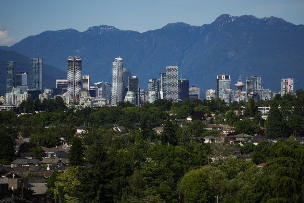 Condo and office towers line the downtown skyline with the north shore mountains in the distance, in Vancouver, on Friday, July 4, 2025. THE CANADIAN PRESS/Darryl Dyck