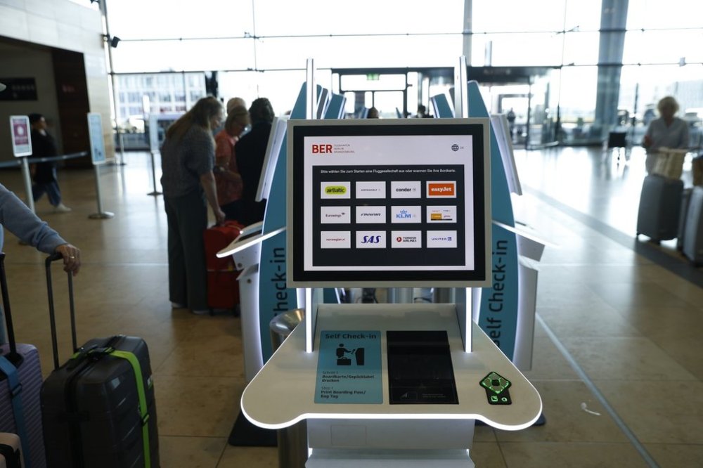 People at BER airport as a cyber attack has caused delays, in Berlin, Germany, Saturday, Sept. 20, 2025. (Carsten Koall/dpa via AP)