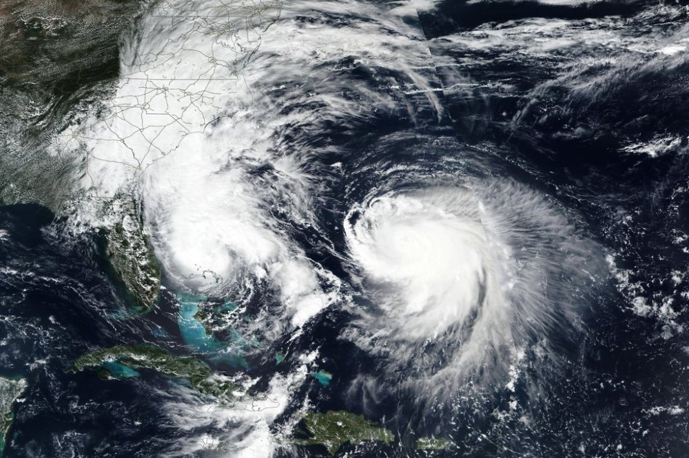 This Monday, Sept. 29, 2025, satellite image released by NASA shows Tropical Storm Imelda, left, and Hurricane Humberto in the Atlantic Ocean. (NASA Worldview, Earth Observing System Data and Information System (EOSDIS) via AP)