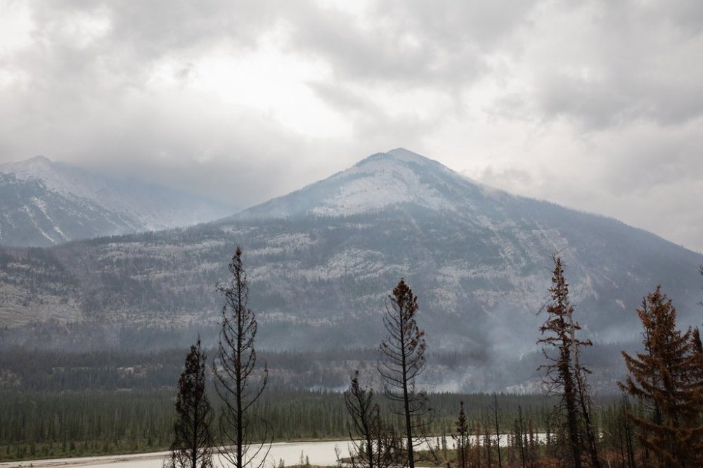 A wildfire smoulders outside of Jasper, Alta., on Friday Aug. 16, 2024. THE CANADIAN PRESS/Amber Bracken