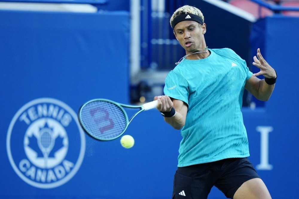 Gabriel Diallo, of Canada, returns a forehand to Taylor Fritz, of the United States of America, during their match at the National Bank Open in Toronto, Friday, Aug. 1, 2025. THE CANADIAN PRESS/Frank Gunn