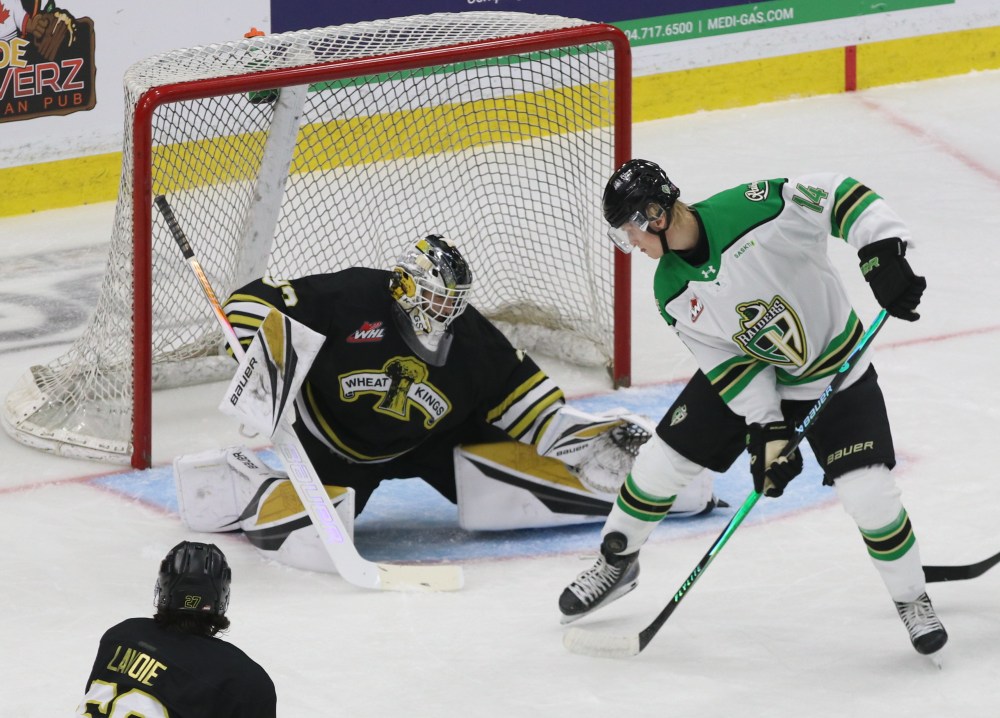 Brandon Wheat Kings goalie Jayden Kraus (33) watches the puck hit the ankle of Prince Albert Raiders forward Max Heise (14) during Western Hockey League action at Assiniboine Credit Union Place on Saturday. (Perry Bergson/The Brandon Sun)
Sept. 27, 2025