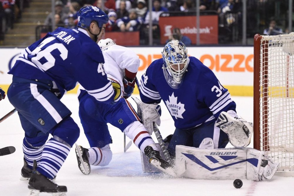 Toronto Maple Leafs goalie James Reimer makes a save on Montreal Canadiens' Alex Galchenyuk (27) as Maple Leafs' Roman Polak (46) defends during third period NHL action in Toronto on Saturday, Jan. 23, 2016. THE CANADIAN PRESS/Frank Gunn