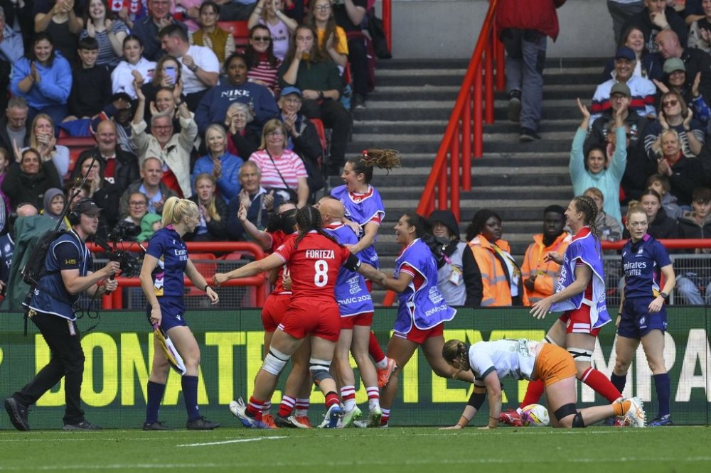 Canada's players celebrate a try during the Women's Rugby World Cup 2025 quarterfinal match between Canada and Australia, in Brighton, England, Saturday, Sept. 13, 2025. (AP Photo/Anthony Upton)