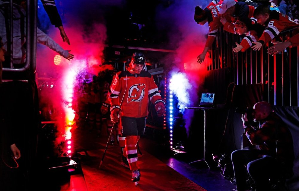 FILE - New Jersey Devils' Luke Hughes (43) walks to the ice for the first period of an NHL hockey game against the Calgary Flames, Thursday, Mar. 20, 2025, in Newark, N.J. (AP Photo/Noah K. Murray, file)