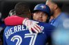 Blue Jays catcher Alejandro Kirk hugs teammate Vladimir Guerrero Jr. after hitting a home run against the New York Yankees during the eighth inning of Game 1 in MLB American League Division Series action in Toronto on Oct. 4, 2025. THE CANADIAN PRESS/Nathan Denette