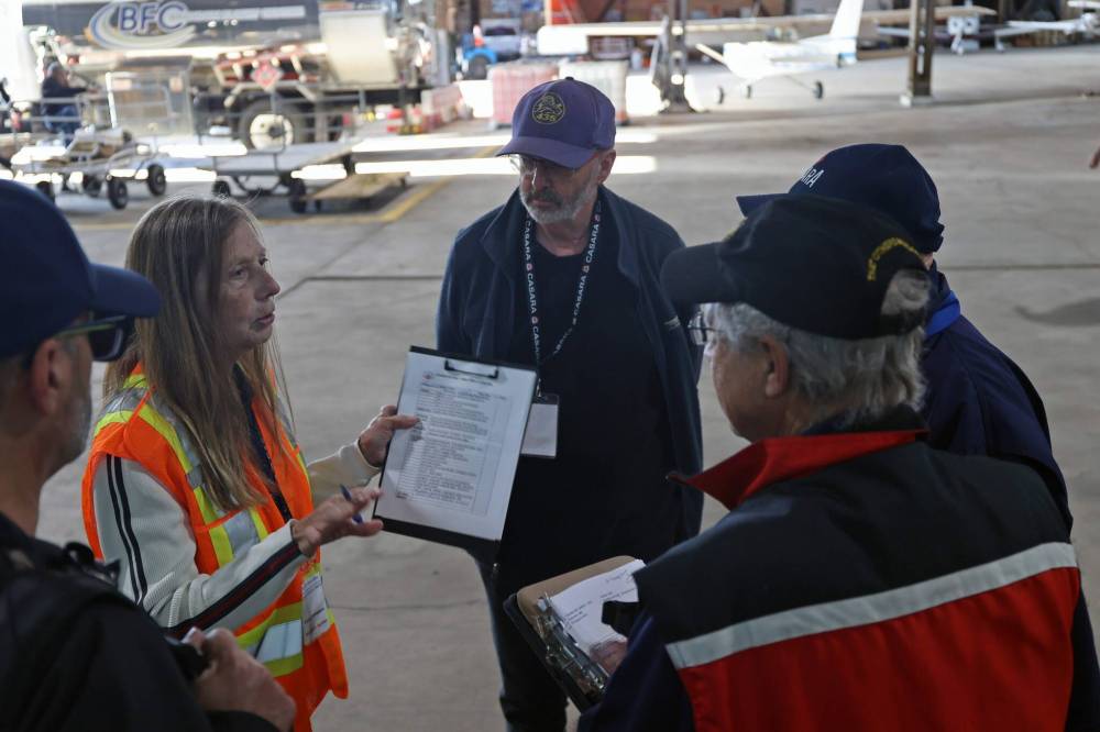Cathy Stevenson, a spotter, organizes a team of civilian search and rescue volunteers before the day of exercises begins. (Connor McDowell/The Brandon Sun)