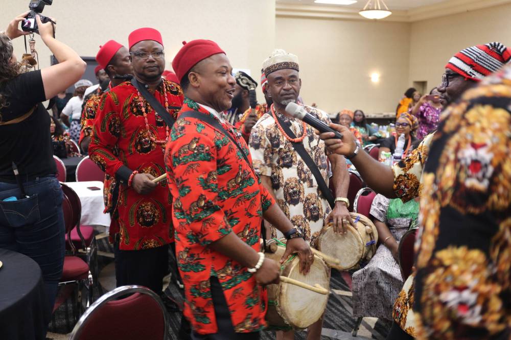 Event co-ordinator Tobe Ekeneme beats a local drum as men of the group sing traditional songs shortly before their performance on Saturday. (Abiola Odutola/The Brandon Sun)