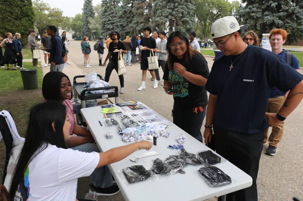 Brandon University Student Union officials (seated) attend to new students during orientation day on the campus Tuesday. (Abiola Odutola/The Brandon Sun)