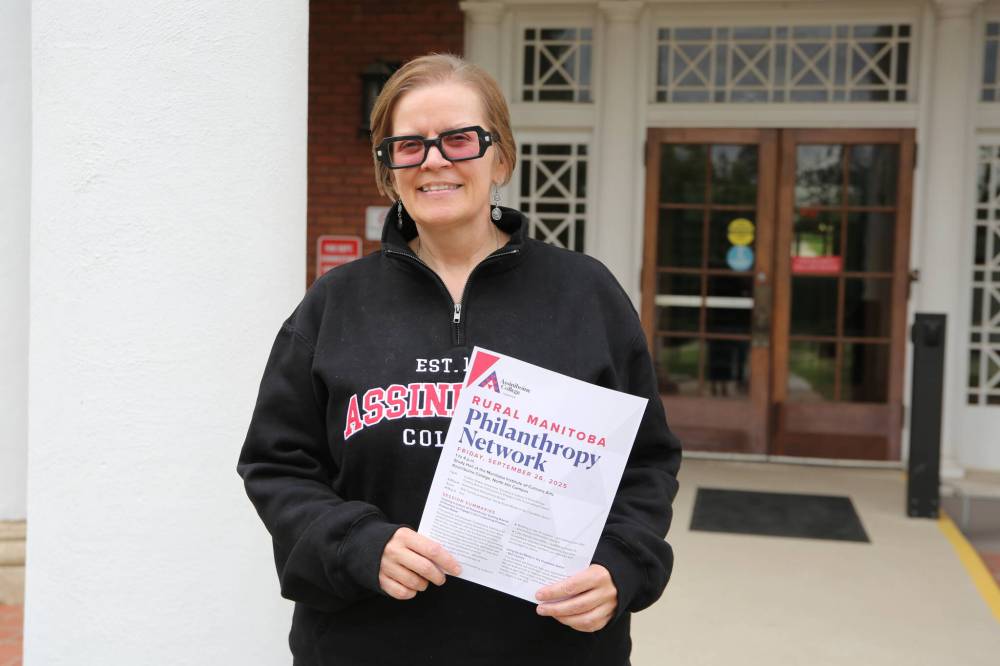 Assiniboine College Foundation major gift officer Beth Proven holds a flyer for the Rural Manitoba Philanthropy Network’s next gathering to be held Sept. 26. (Abiola Odutola/The Brandon Sun)