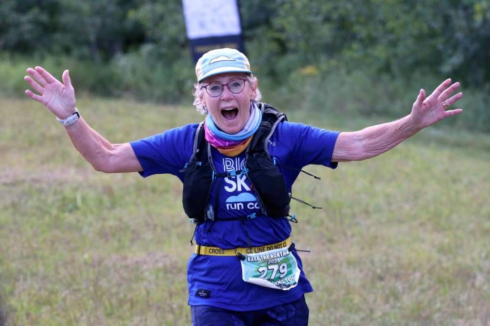Linda Hamilton of Winnipeg, 68, celebrates as she nears the finish line of her 25-kilometre race at the Race the North Face Brandon Hills on Saturday. (Perry Bergson/The Brandon Sun)