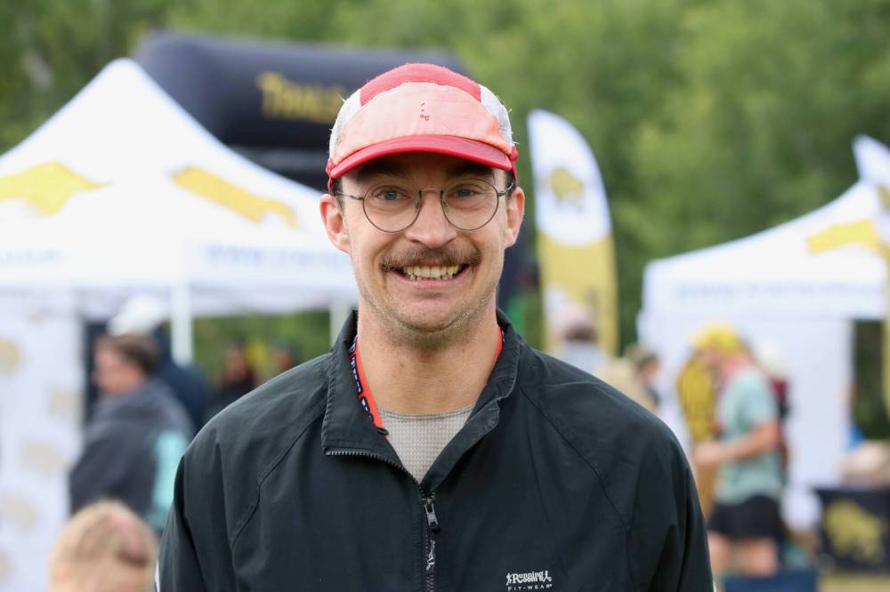 Scott Dodds of Winnipeg poses in front of the finish line of Race the North Face Brandon Hills on Saturday after shattering the 50-km record by more than 13 minutes. (Perry Bergson/The Brandon Sun)