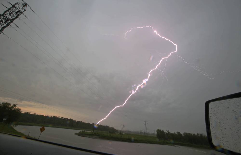A lightning bolt streaks through the sky overlooking the Assiniboine River, as seen from the Manitoba Hydro Brandon Generating Station during a strong thunderstorm that rolled through western Manitoba in August 2020. (Matt Goerzen/The Brandon Sun files)