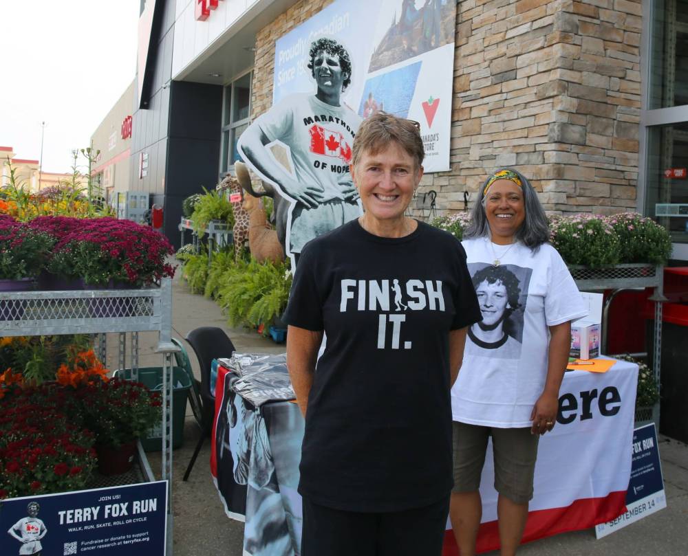 Heather Stewart (left) and Trish Toth, volunteers with the Terry Fox Foundation, are taking donations and registrations for this Sunday's Terry Fox Run outside the Brandon location of Canadian Tire each day this week from 1 to 6 p.m. (Michele McDougall/The Brandon Sun)