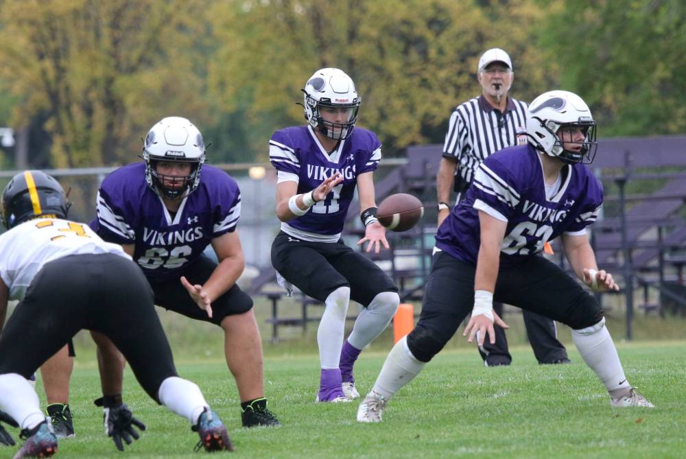 Vincent Massey Vikings offensive linemen Jack Ficek (66) and Grayden Clements (63) backpedal to block for quarterback Charlie Gauthier (11) during their Winnipeg High School Football League game at Doug Steeves Field on Thursday. (Thomas Friesen/The Brandon Sun)