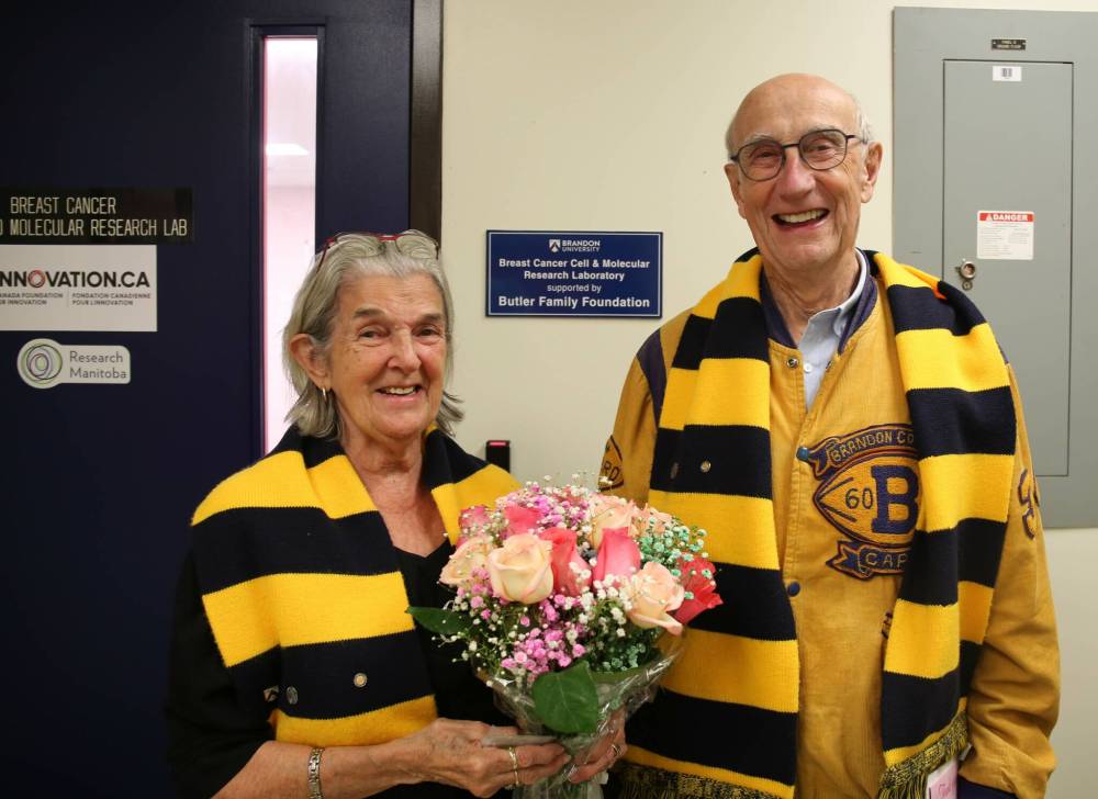 Gerald and Carmen Butler, longtime supporters of Brandon University and the Breast Cancer Cell and Molecular Research Laboratory, stand in front of a plaque put up in honour of their family foundation on Friday afternoon. (Michele McDougall/The Brandon Sun)